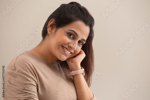 PORTRAIT OF A CONFIDENT WOMAN SMILING AT CAMERA photo