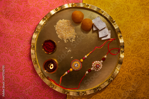 Vászonkép Decorative thali filled with rakhi and sweets on the occasion of Rakshabandhan