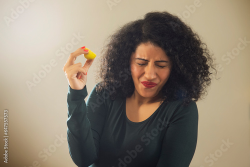 Woman's expression after eating sour lemon