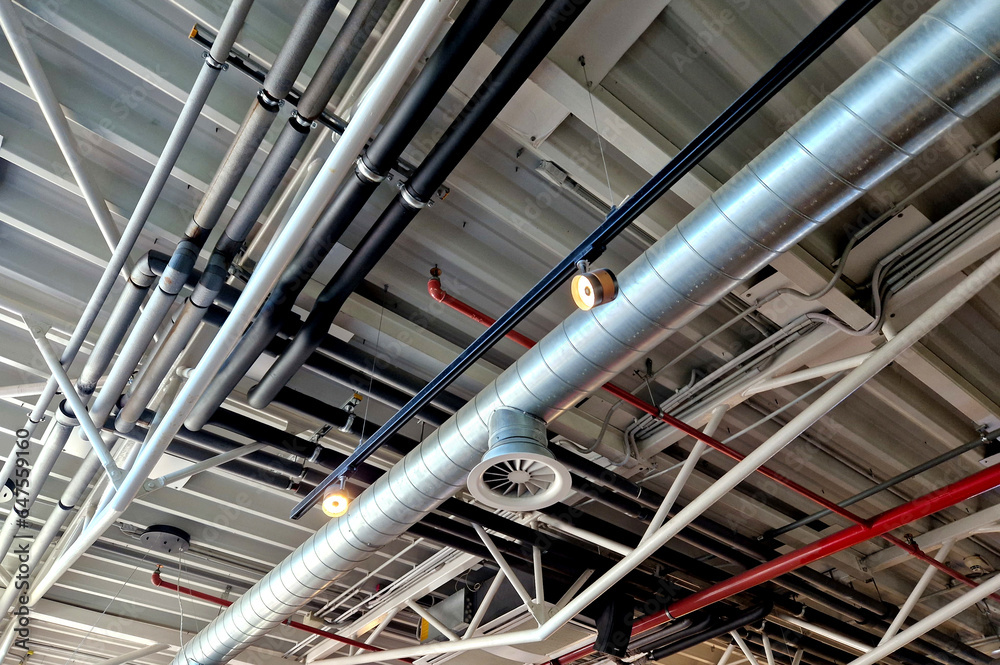 the air handling unit is on the ceiling of the building and is visibly left uncovered. the lights and pipes running under the tin roof give it an industrial feel. whire, suspended ceiling the air handling unit is on the ceiling of the building and is visibly left uncovered. the lights and pipes running under the tin roof give it an industrial feel. whire, suspended ceiling