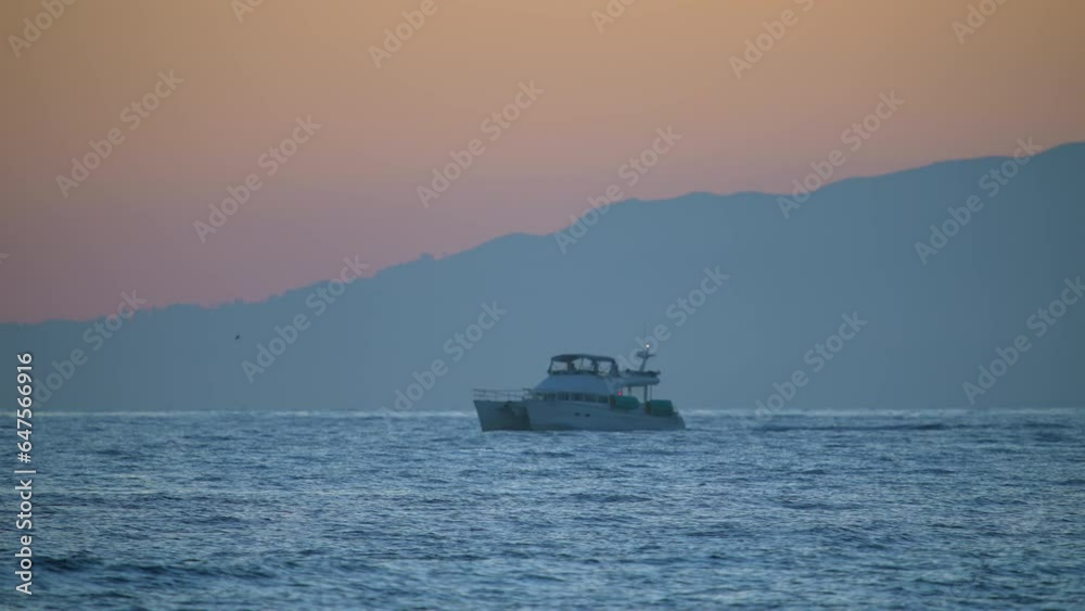 A luxury yacht in the harbor at sunset - slow motion A luxury yacht in the harbor at sunset - slow motion