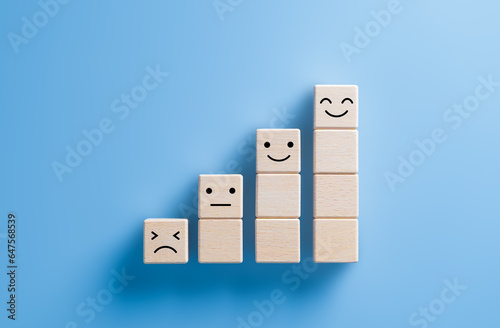 Business growth steps, wooden cube stacked with sad to happy emotions. Service or prodcut satisfaction, evaluation, customer review, rating survey concept. Emotional state and mental health day.