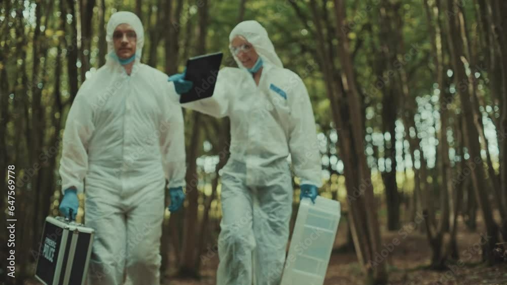 Forensic police investigators arriving at a crime scene and assessing the situation. Taping and marking the crime scene Forensic police investigators arriving at a crime scene and assessing the situation. Taping and marking the crime scene