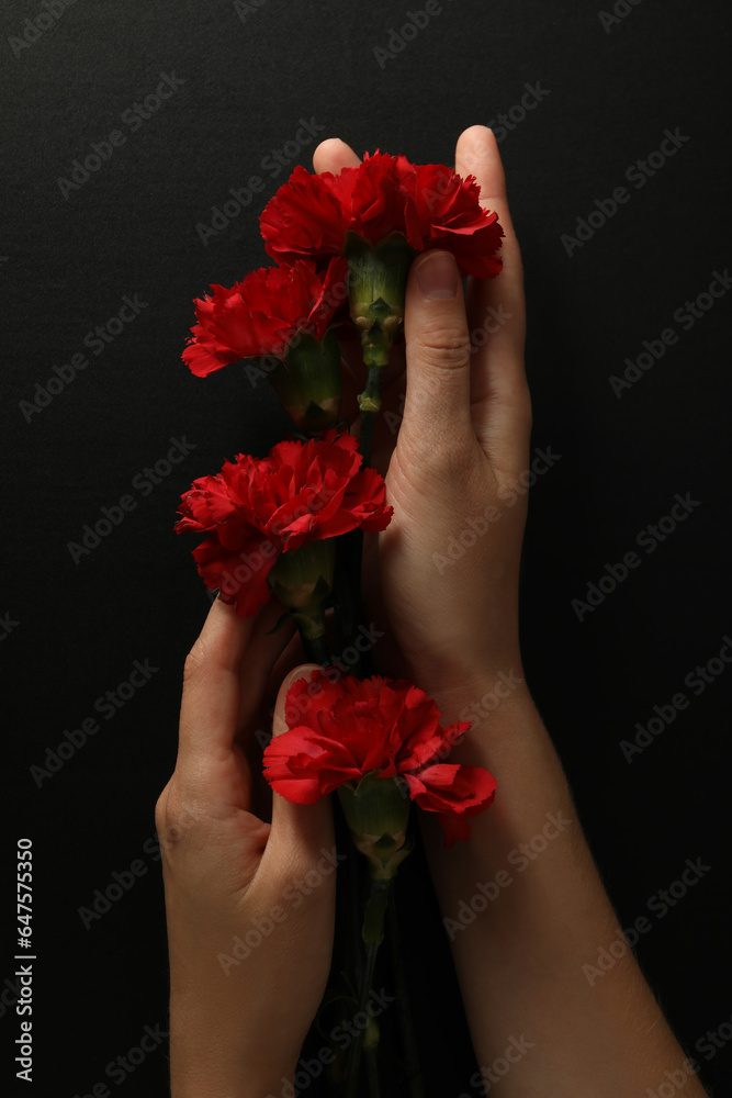 Red flowers of sorrow, on a dark background.
