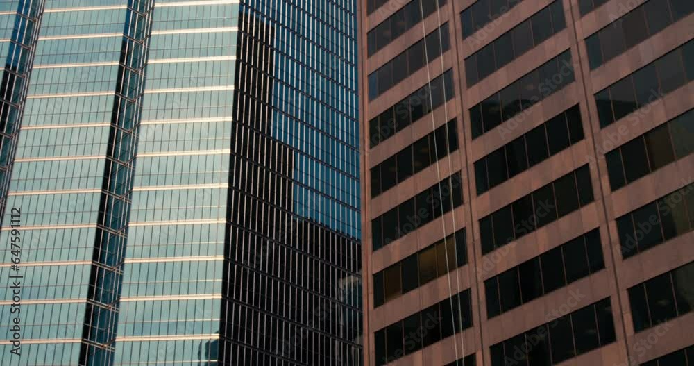 Downtown skyscraper extravaganza: breathtaking view from below focusing on towering windows of downtown. Capture the essence of downtown city life through reinforced concrete office buildings Downtown skyscraper extravaganza: breathtaking view from below focusing on towering windows of downtown. Capture the essence of downtown city life through reinforced concrete office buildings