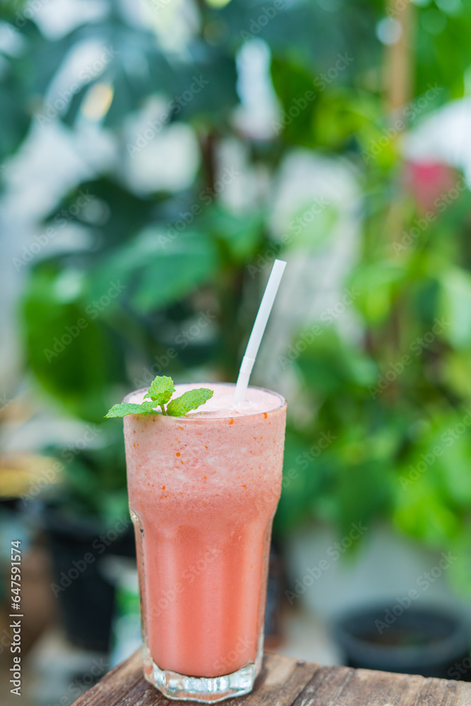 Cool, refreshing watermelon smoothie in a transparent glass. Leave space for letters. Cool, refreshing watermelon smoothie in a transparent glass. Leave space for letters.