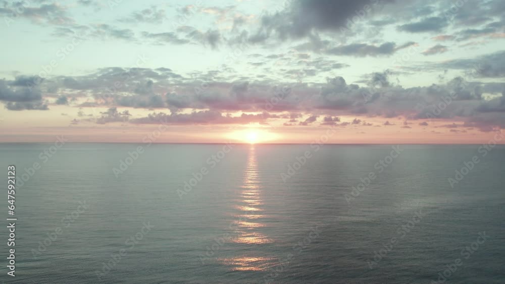 Sunset over calm, crystal clear oceans as waves roll in. Dramatic Clouds. Aerial push-in shot. Tulum, Mexico Sunset over calm, crystal clear oceans as waves roll in. Dramatic Clouds. Aerial push-in shot. Tulum, Mexico