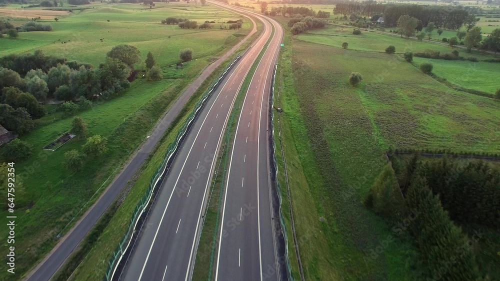 Aerial of Cars on Countryside Highway Road at Sunset
