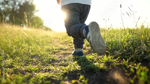 kid run legs close-up in the park at sunset. happy family. people in the park concept boy son joyful run. happy family summer. little baby run child fun summer kid lifestyle dream concept