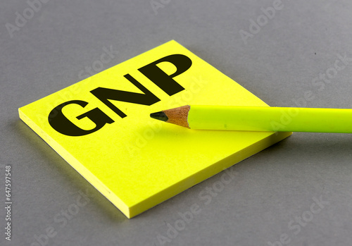 GNP text written on a sticky on grey background photo