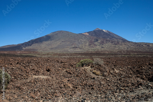 Panoramic view of El Teide from a distance with detailed soil texture in the foreground