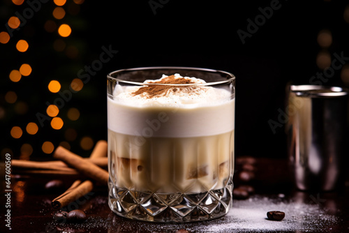 Horchata cocktail with creamy made by coffee liqueur swirl of half below whipped cream decorated by cinnamon powder and cinnamon stick on bokeh background 