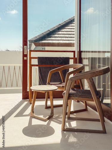 Two wooden chairs and a coffee table on the terrace