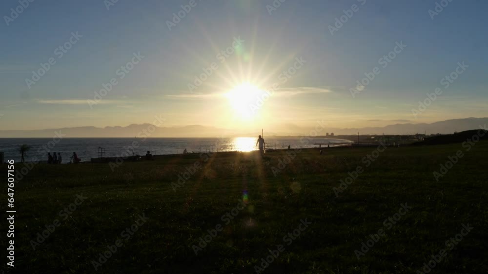 A view of the setting sun from a seaside park. A view of the setting sun from a seaside park.