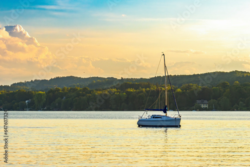 A boat rocks on the lake before sunset in pleasant late summer weather.