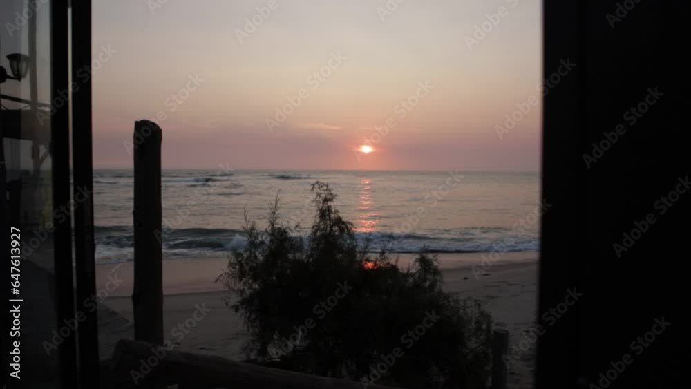A slow reveal shot of a gorgeous sunset over the ocean with blue and pink hues A slow reveal shot of a gorgeous sunset over the ocean with blue and pink hues