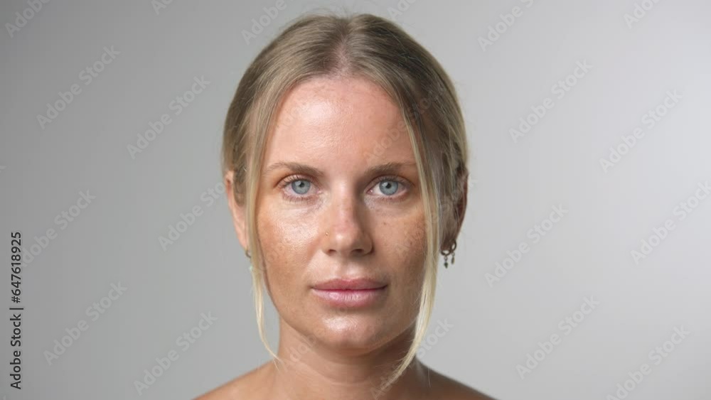 Beautiful person look at camera close up. Young adult woman face portrait. Stylish 30 years old girl on isolated white background. Attractive female feminism model. Modern millennial feminist people.