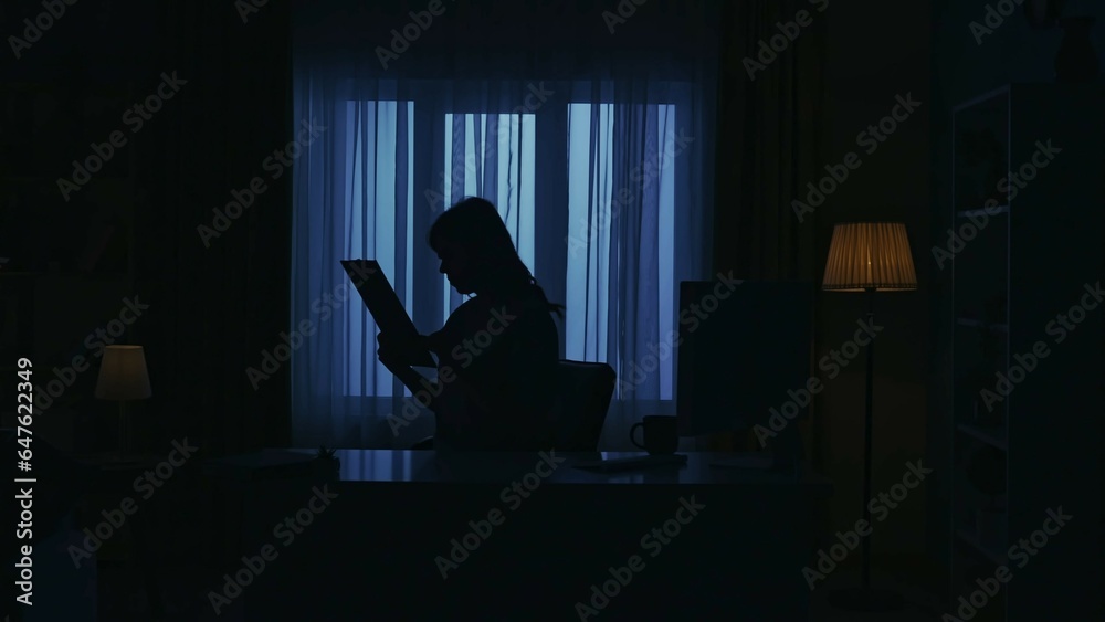 Everyday life creative concept. Woman at home at the desk working with paper documents, reading information. Everyday life creative concept. Woman at home at the desk working with paper documents, reading information.