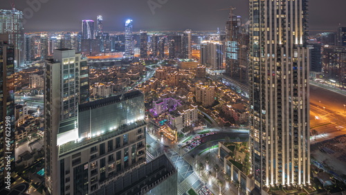 Panorama showing aerial view of a big futuristic city night timelapse. Business bay and Downtown