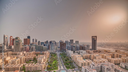 Canvas Print Sunrise over skyscrapers in Barsha Heights district and low rise buildings in Greens district aerial timelapse