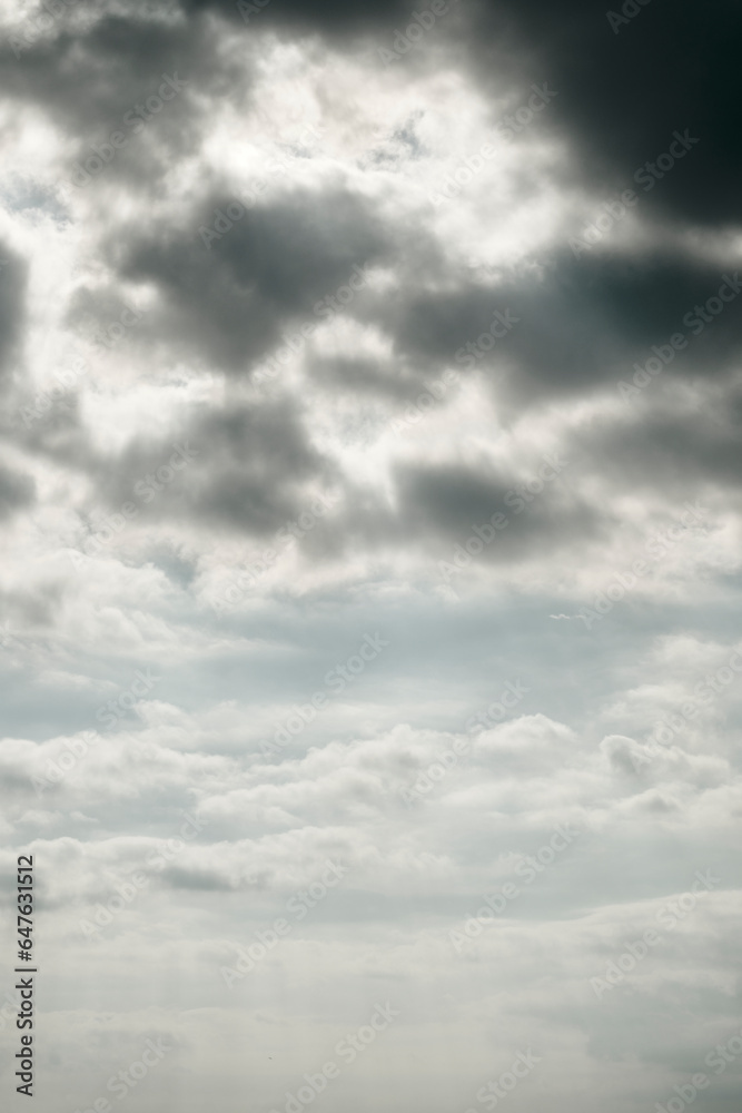 Sky background with light and dark clouds