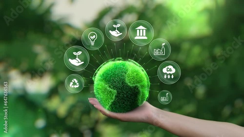 Ecology icon concept. ESG environment, society and governance. Saving the green planet in the hands of humans on green background.