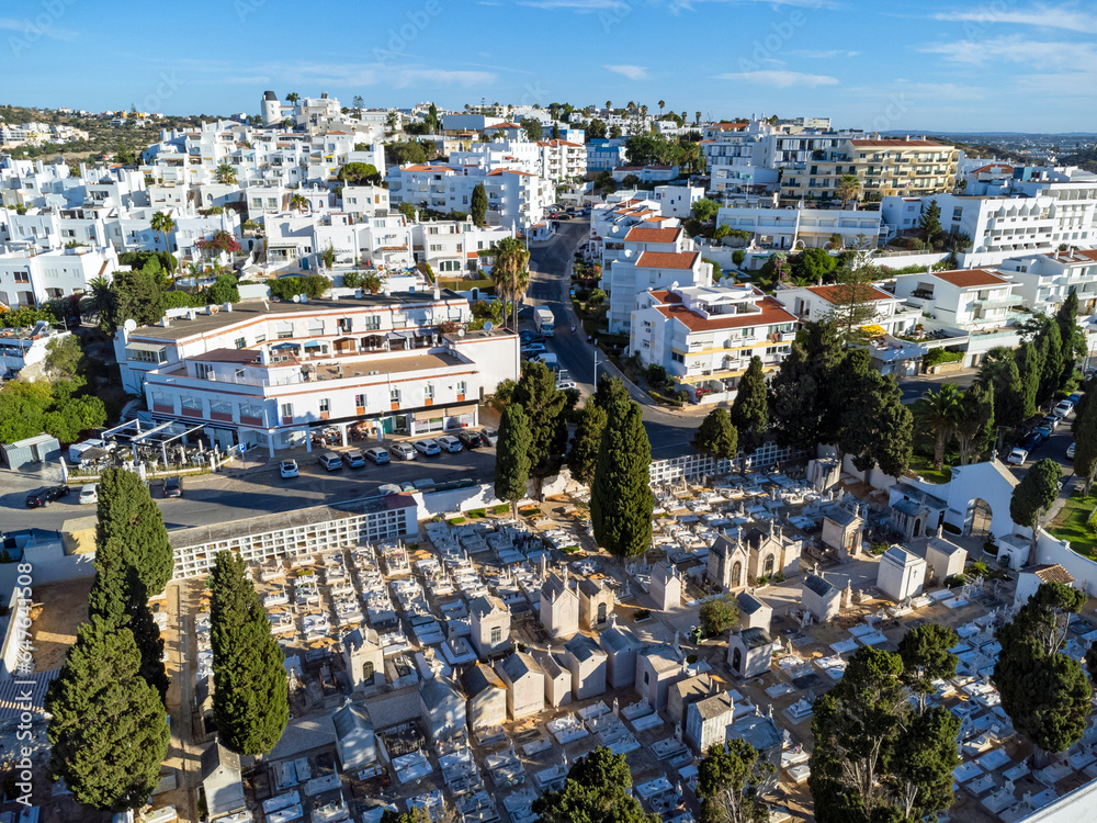 Aerial view landscape, drone view of town, white houses, cemetery and green surroundings. Portugal Algarve.