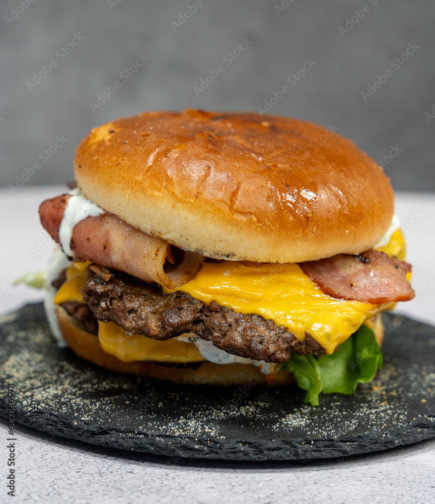Burger with meat cutlet, hamburger isolated on grey background. Tasty Hamburger. Restaurant dish. 