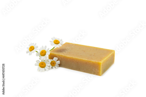 Natural homemade soap with chamomile flowers isolated on a white background. Close-up of moisturizing soap with natural herbal oils. Spa and beauty concept.