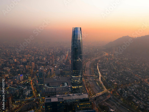 Aerial View Of Tall Skyscraper And Cityscape During Smoggy Sunset In Downtown Santiago, Chile. photo