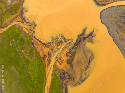 Aerial view of abstract water formation from river estuary along the coastline in Hvolsvollur, Southern Region, Iceland.