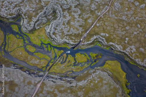 Aerial view of a road crossing the Ulfarsdalur river streaming across the valley, Kirkjubaejarklaustur, Southern region, Iceland. photo