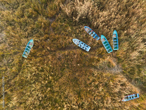 Aerial view of boats parked in the high grass on the shore of Rawal Dam, Bani Gala Islamabad Capital Territory, Pakistan. photo