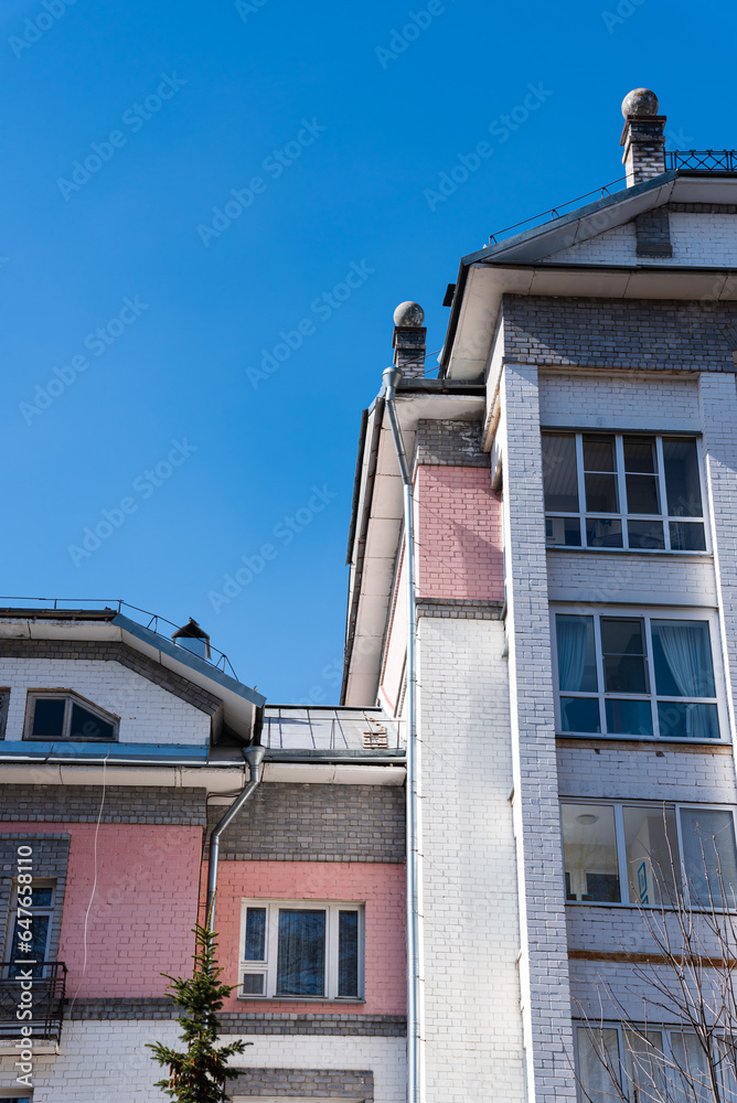 Modern residential multi-storey building against the blue sky. Modern residential multi-storey building against the blue sky.