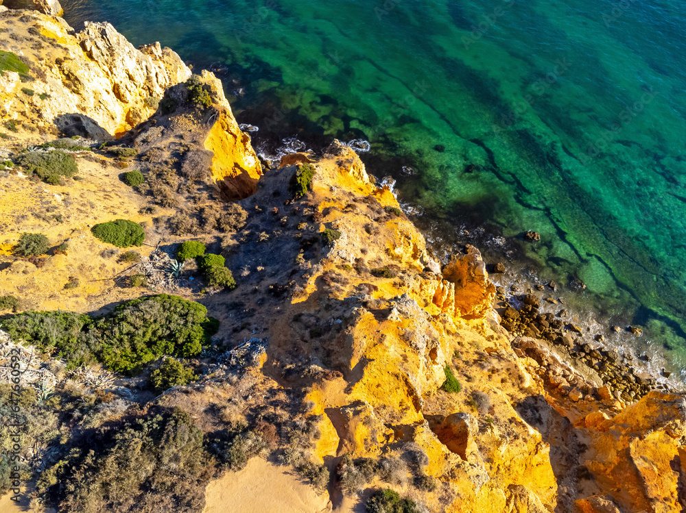 Aerial view landscape, view of an empty, clean, beautiful rocky beach. Photo from a drone. Portugal, Lagos, Algarve region.