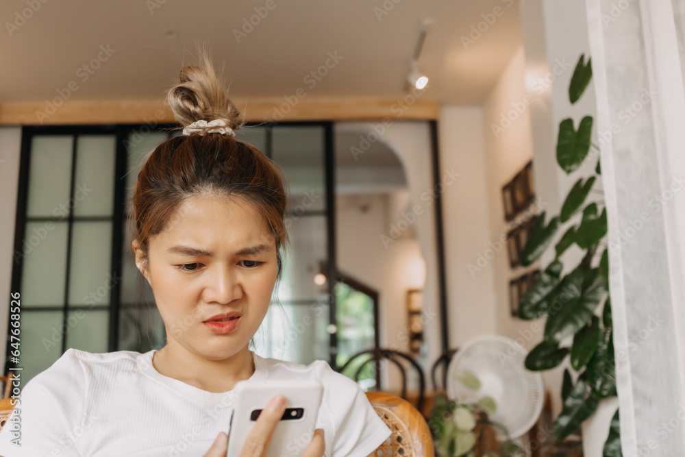 Asian women dislike face looking at the smartphone. Asian women dislike face looking at the smartphone.