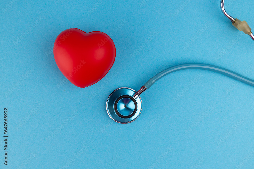 A stethoscope and a red heart on a blue background with a copy space. Banner. medicine health, medical pharmacy, healthy lifestyle, concept A stethoscope and a red heart on a blue background with a copy space. Banner. medicine health, medical pharmacy, healthy lifestyle, concept