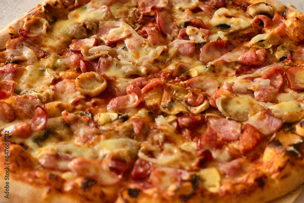 Delicious pizza with sausage, tomatoes and cheese Delicious pizza with sausage, tomatoes and cheese