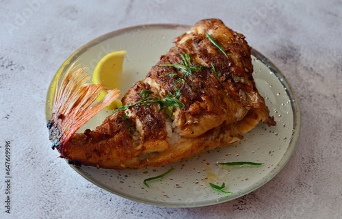Delicious fried sea bass with lemon and herbs