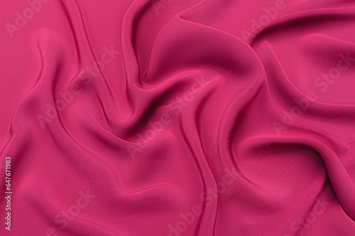 Close-up texture of natural red or pink fabric or cloth in same color. Fabric texture of natural cotton, silk or wool, or linen textile material. Red and pink canvas background.