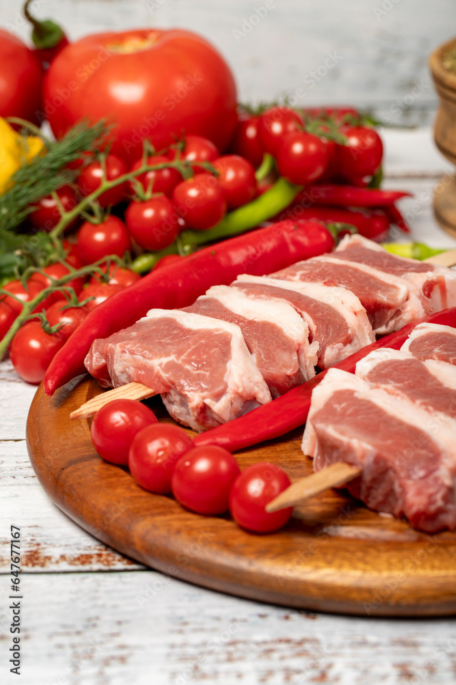 Raw lamb tenderloin on wood background. Raw lamb tenderloin with herbs and spices