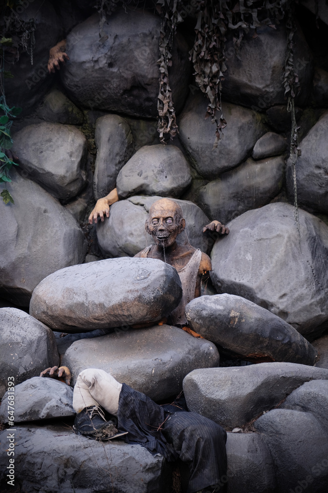 Zombie figure on the rocks for Halloween decoration