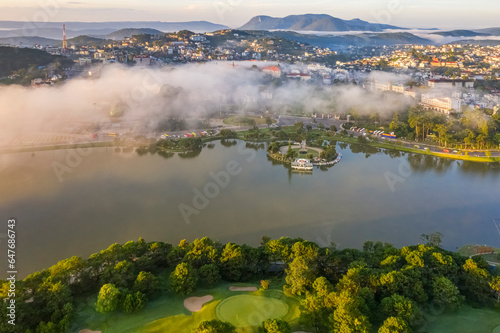 Top view aerial photo from flying drone of a Da Lat City with development buildings, transportation, nature beautifull, famoust travel city of Vietnam.