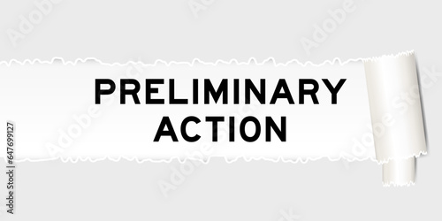 Ripped gray paper background that have word preliminary action under torn part