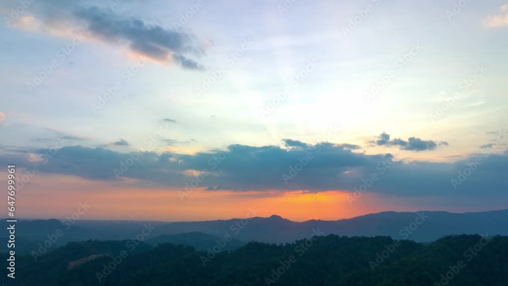 aerial hyperlapse view light through the cloud above the mountain range..beautiful sky in sunset cloud over the mountain. red sun going down to mountain ridge..beautiful nature background.4k video