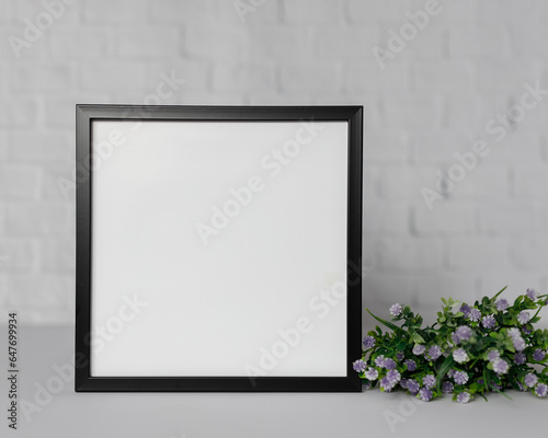 Minimal wooden picture poster frame mockup on white wallpaper © Katarzyna