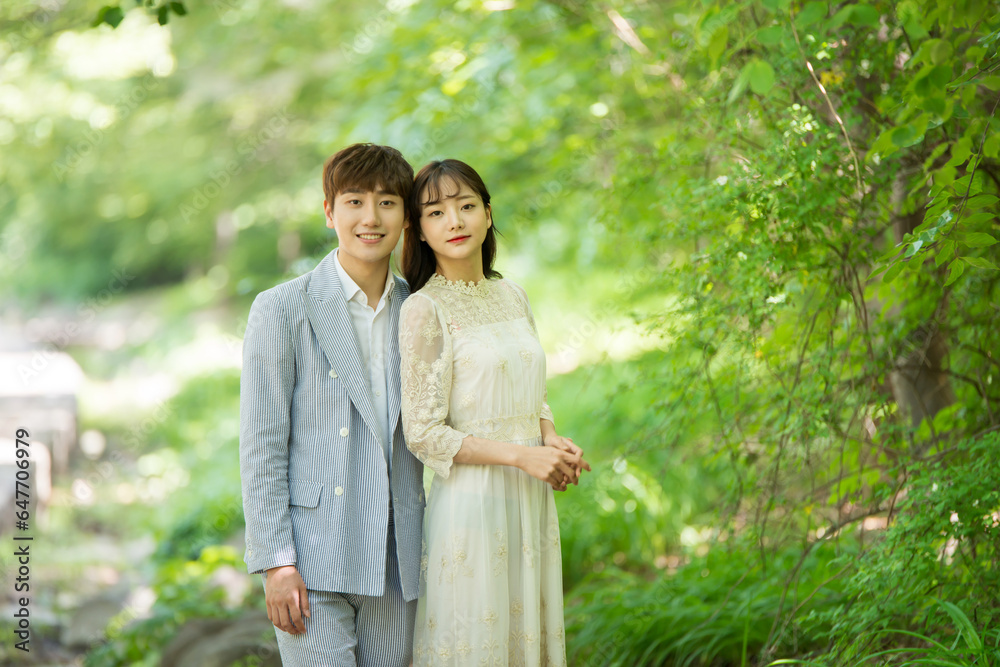 A loving couple is taking wedding photos outdoors for their wedding. A loving couple is taking wedding photos outdoors for their wedding.