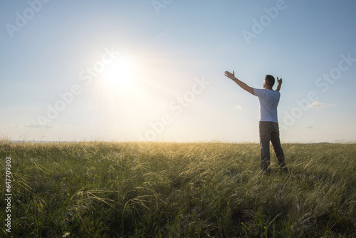 Happy man raised hands at sunset. man outdoor harmony with nature.