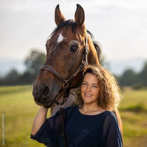 Horse woman head portraits in color, horse attentive woman smiling..