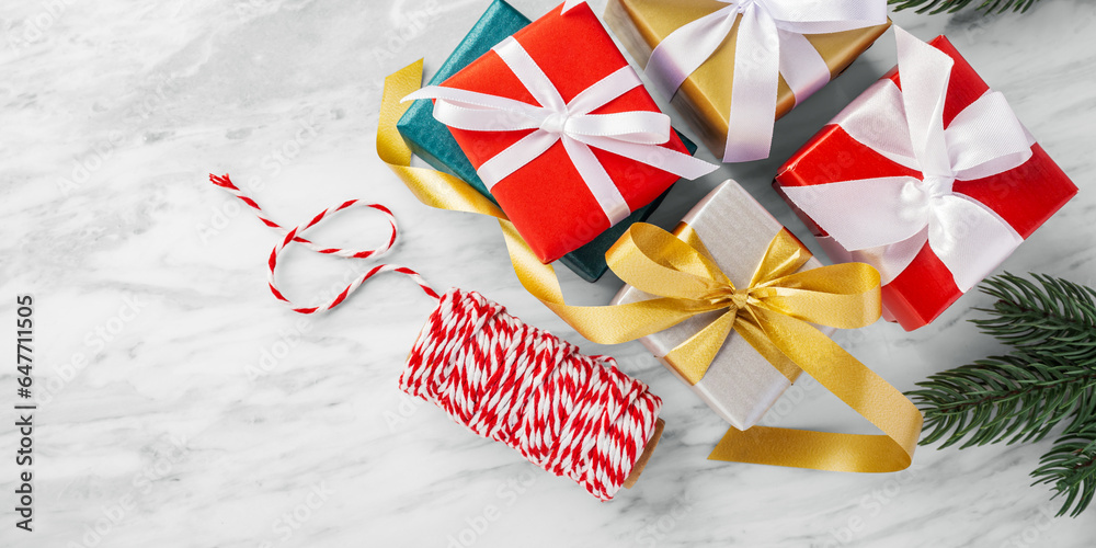 Fototapeta premium Christmas gift box, present and ribbon on white marble table
